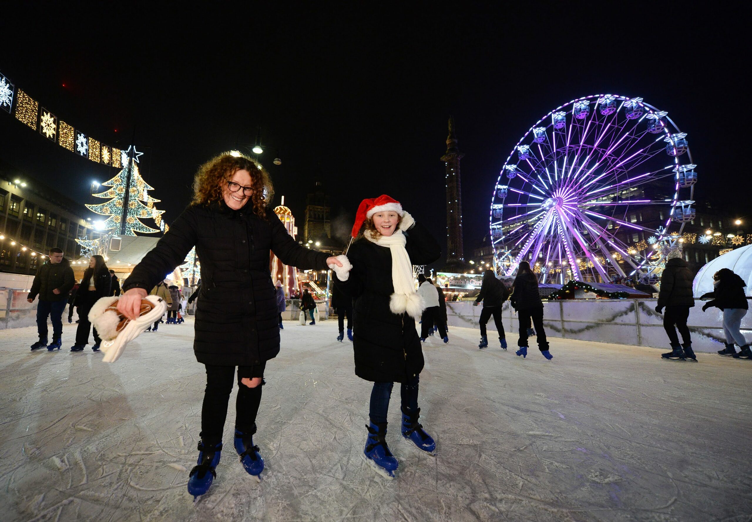 George Square, Glasgow and St Enoch Xmas Market 2022 shot for M&Ds. NOTE: All wide shots with lots of people in frame there is no photography consent for all people but any close up of childrens, people looking at camera, posed up or close to camera were spoken to and told it was for marketing of market and M&Ds. Anne Telford, 10 and mum Janet Telford, and sister Sophie to right in puffer.